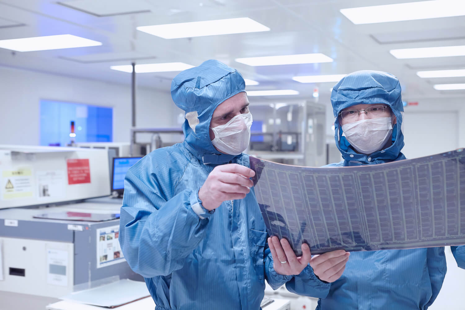 Cleanroom workers holding a flexible circuit