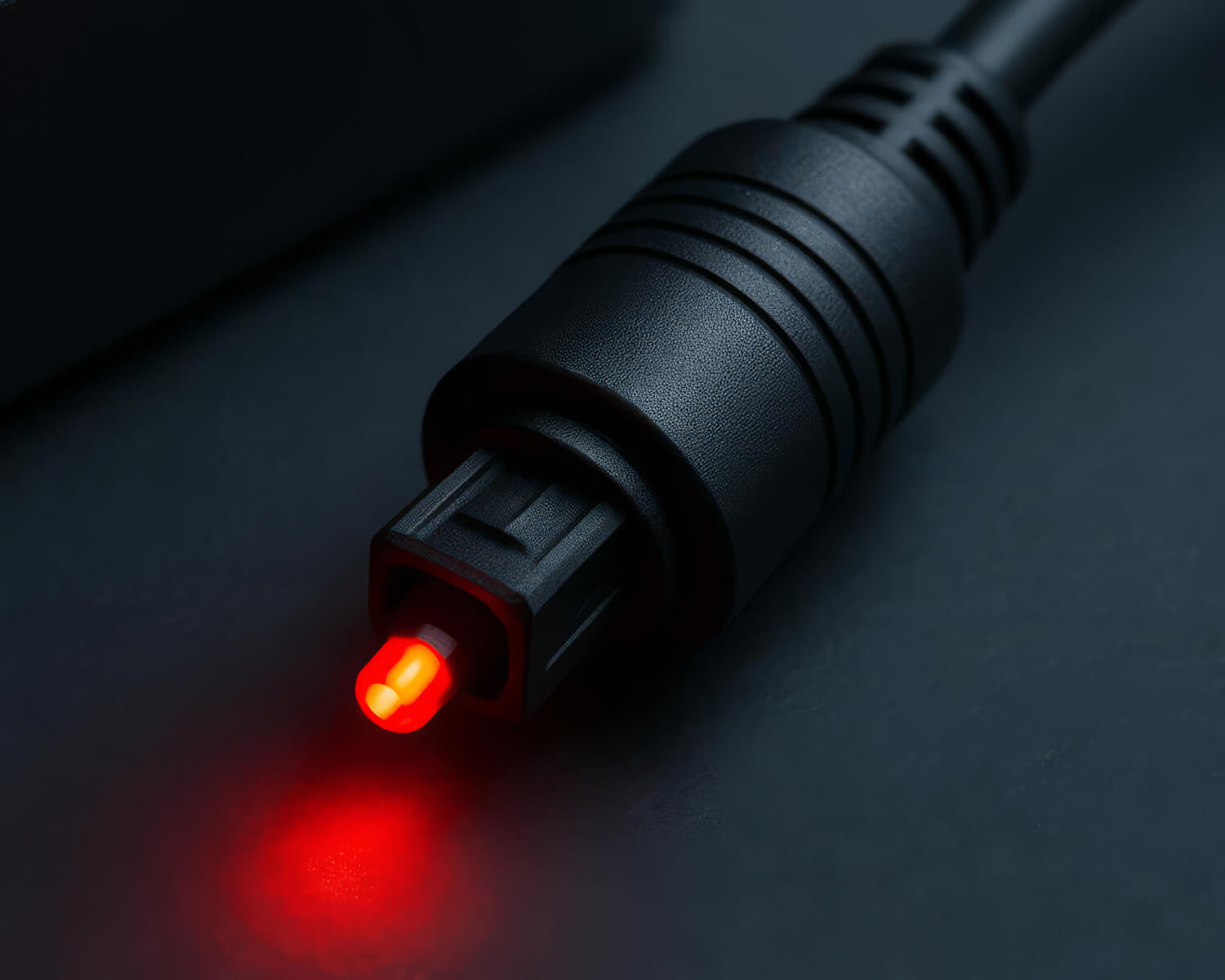 Toslink connector with a red light, indicating an active optical signal